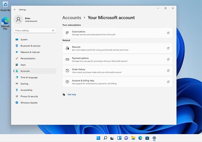 Image of Windows 11 desktop with the Settings window open, displaying the users microsoft account options. Microsoft has added a Your Microsoft Account page to Windows 11’s Settings.