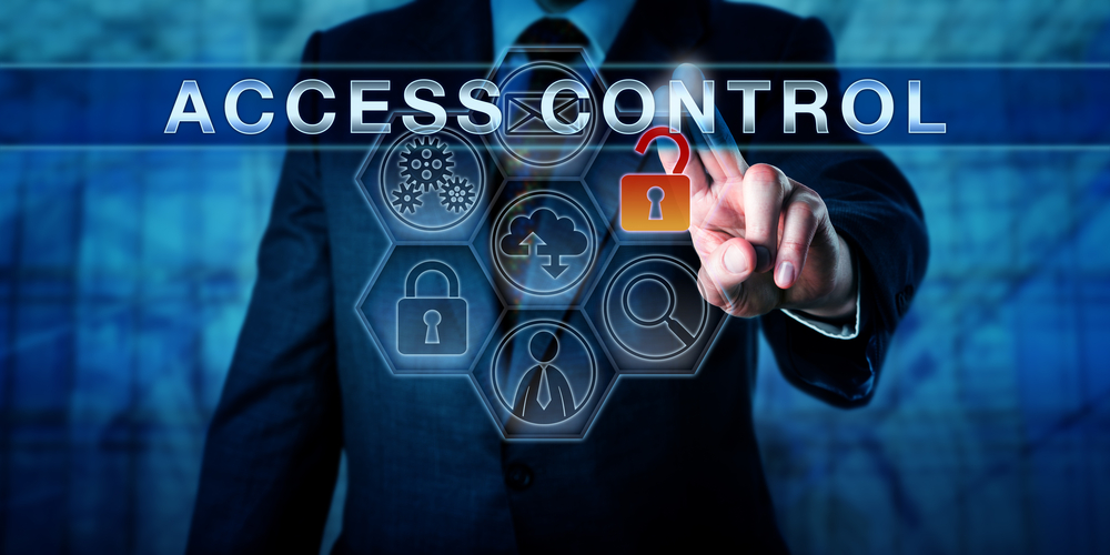 Image showing a person using a transparent touch-panel that contains several options including access control. The panel is made up of a honeycombe containing icons including an open red padlock the person is touching. The words 'access control' are overlaid on the image.