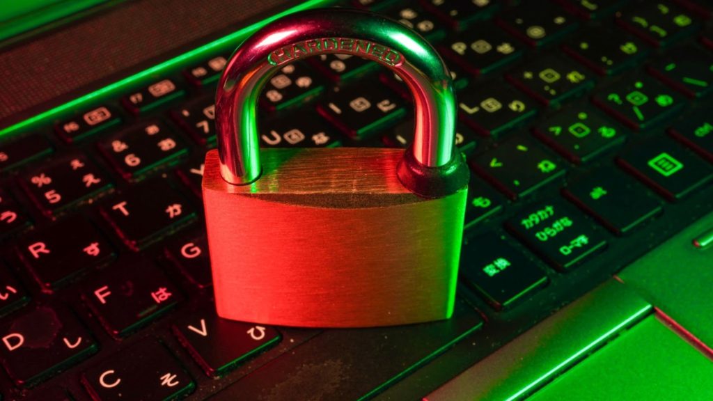 Image of a lock sitting on a computer keyboard.