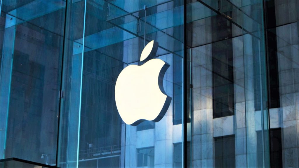 Image of the Apple Logo on the side of a glass building.