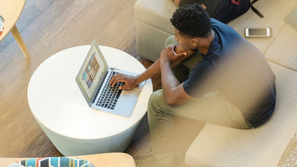 Image of a person sitting comfortably with a laptop.