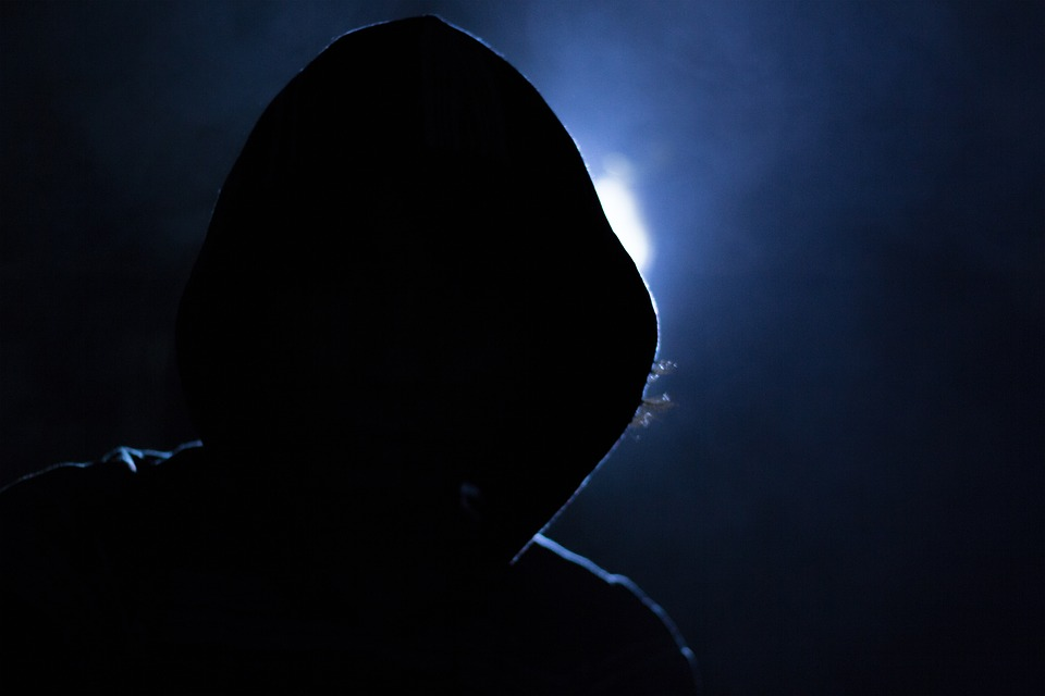 Image showing a dark hooded figure staring at you ominously.