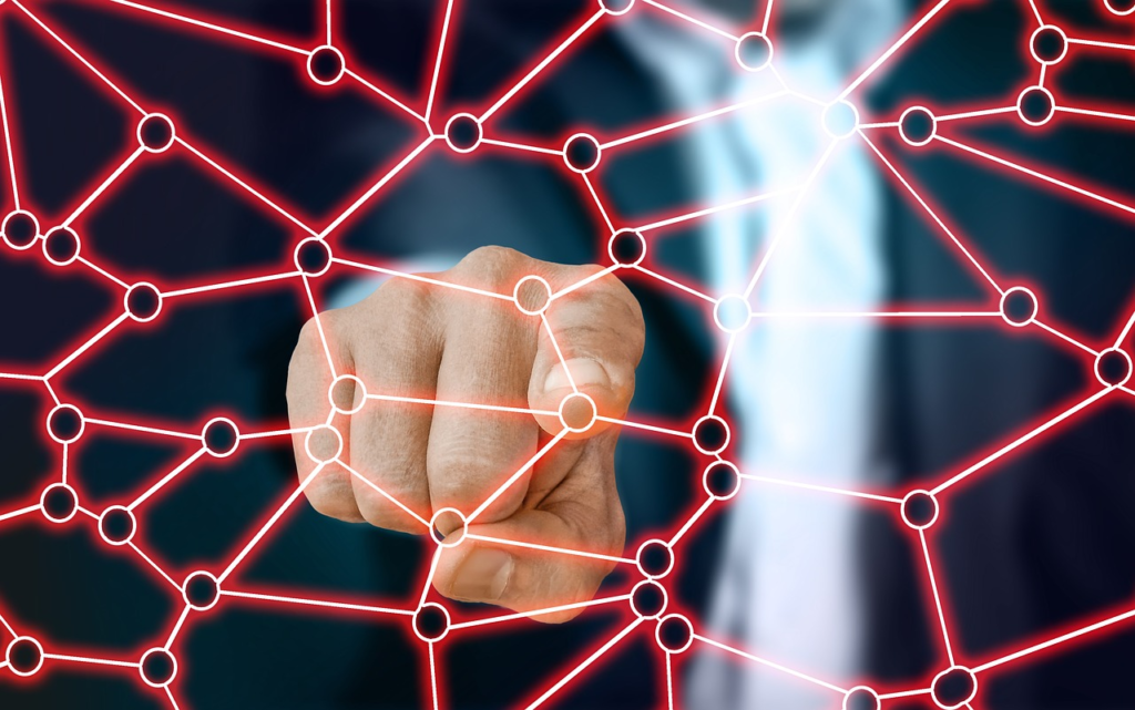 Photoillustration of a finger pointing to a network node superimposed on image.