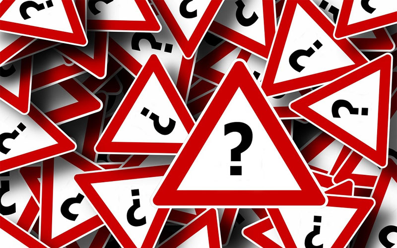 Image of warning signs with question marks on them.