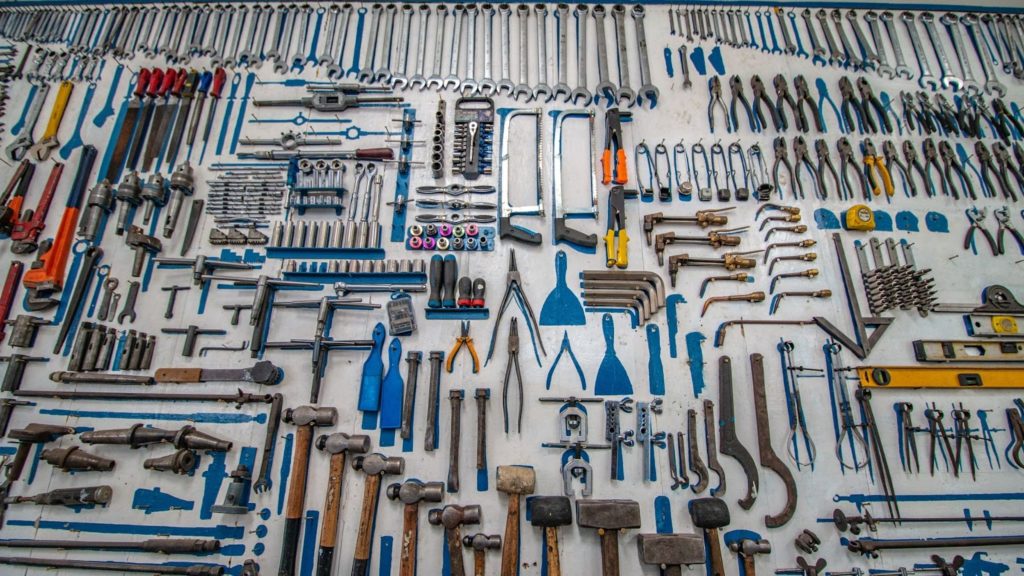 Image of different tools spread on a wall.