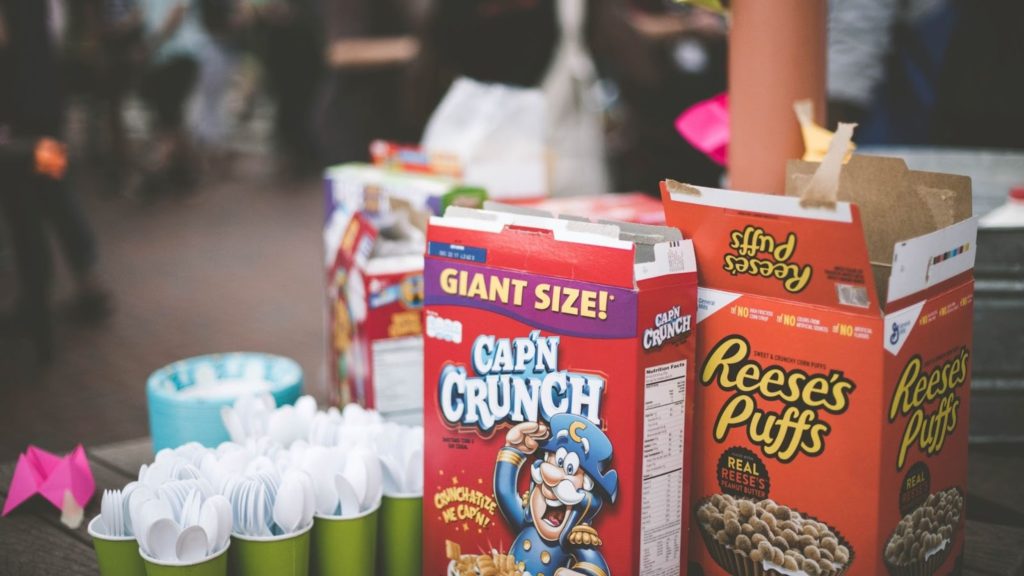 Image of boxes of Cap'N Crunch and Reese's Puffs with plastic utensils.
