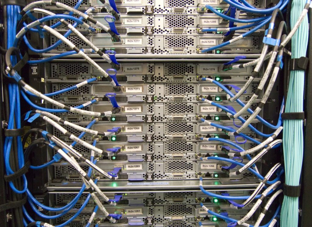 An image of a server with many cables plugged into it.