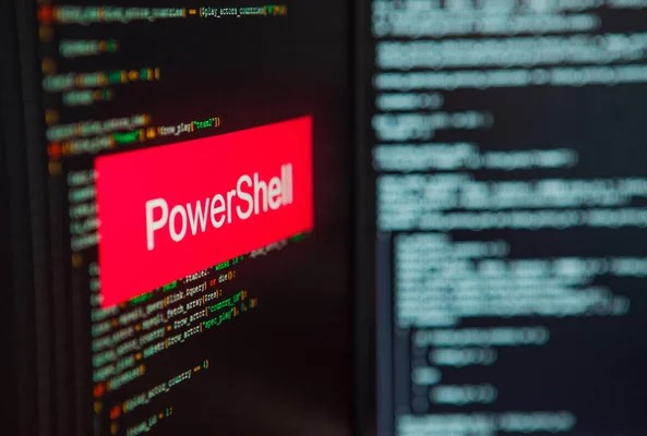 A graphic image of PowerShell inscription on the background of a computer.