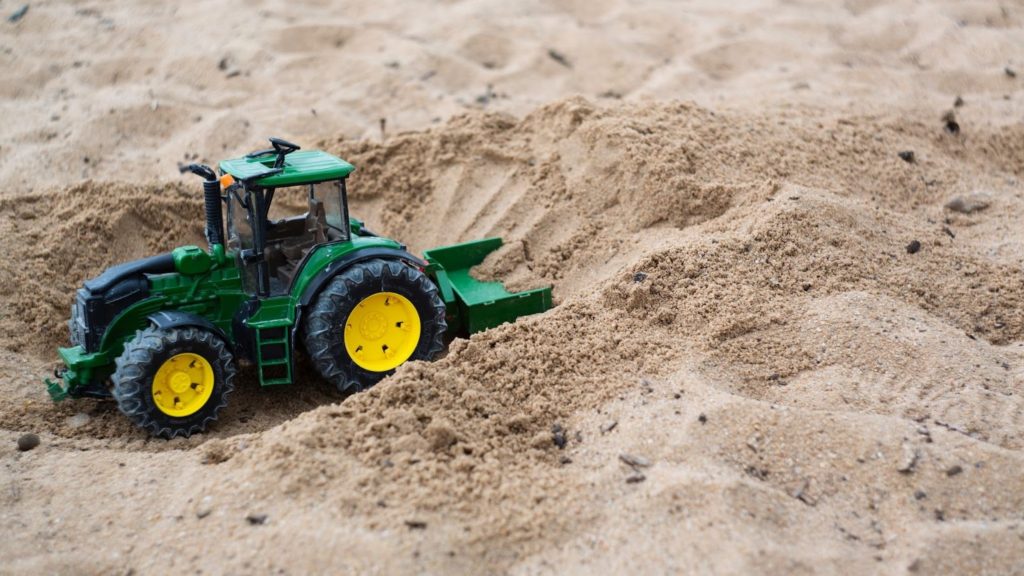 An image of a toy truck in a sandbox.