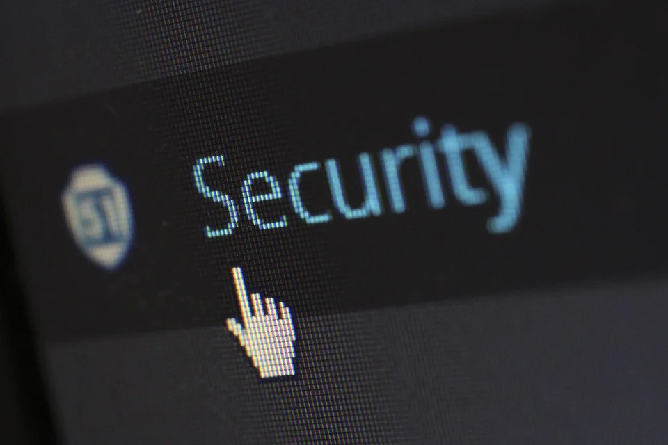 Image of a digital finger pointing to the word security on a screen.