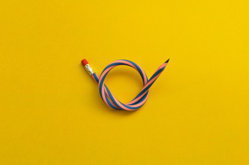 An image of as flexible pencil twisted into a loop.