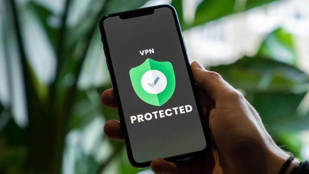 An image of a person holding a phone with VPN service enabled.