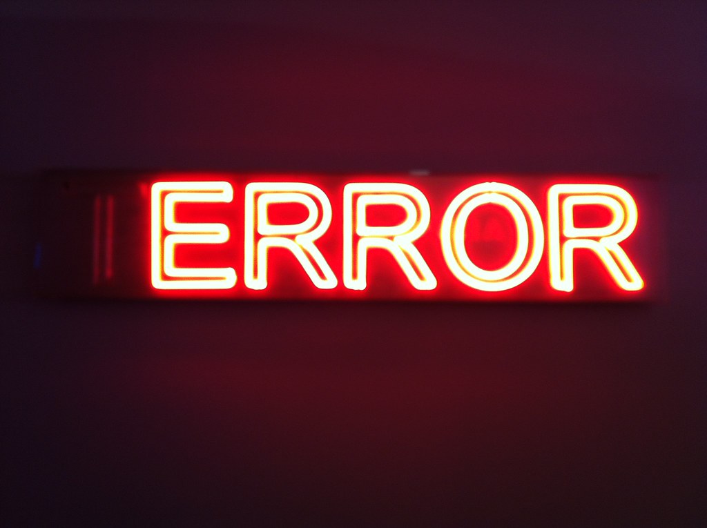 Image of a red neon error sign.
