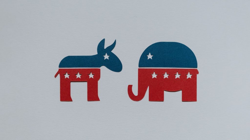 Symbols of Democrat and Republican parties cut out of paper.