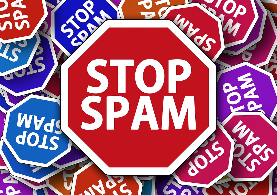 An image of several stop signs that all have the words "STOP SPAM" written on them.