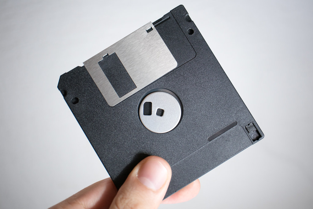Image of a floppy disk being held up.