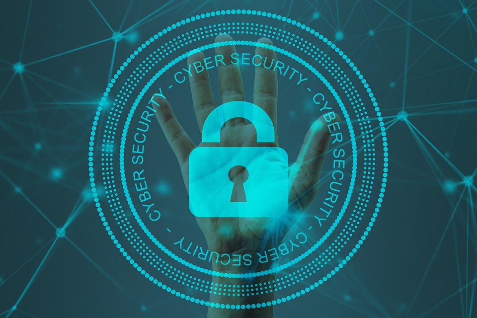 Image showing a lock with a hand in the background and the word "cybersecurity" written around the lock 4 times.