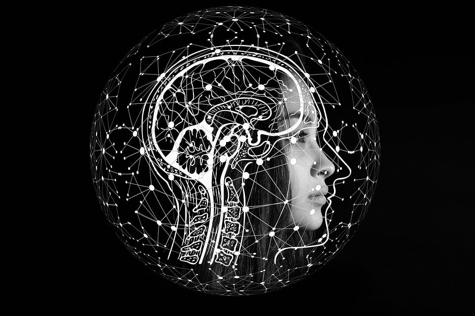 A lady's face with a visualization of her brain. It's connected by different points on a network.