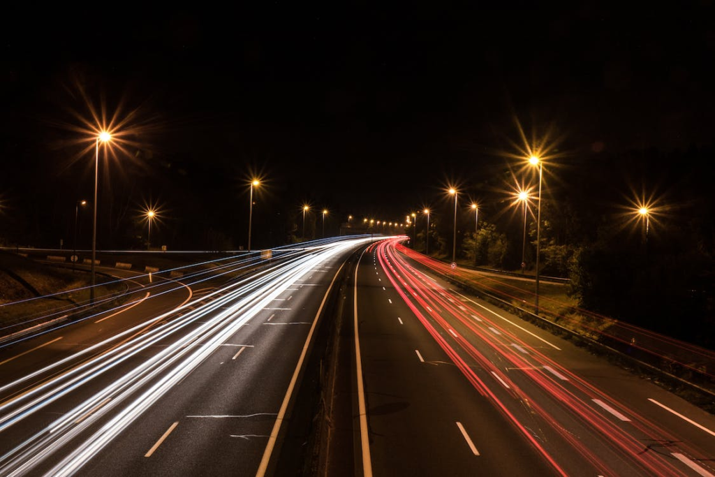Image of lights overexposed on a highway at night.