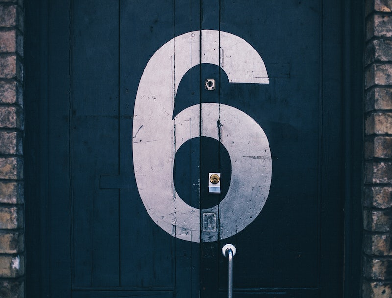 Image of a door painted with a large number six.